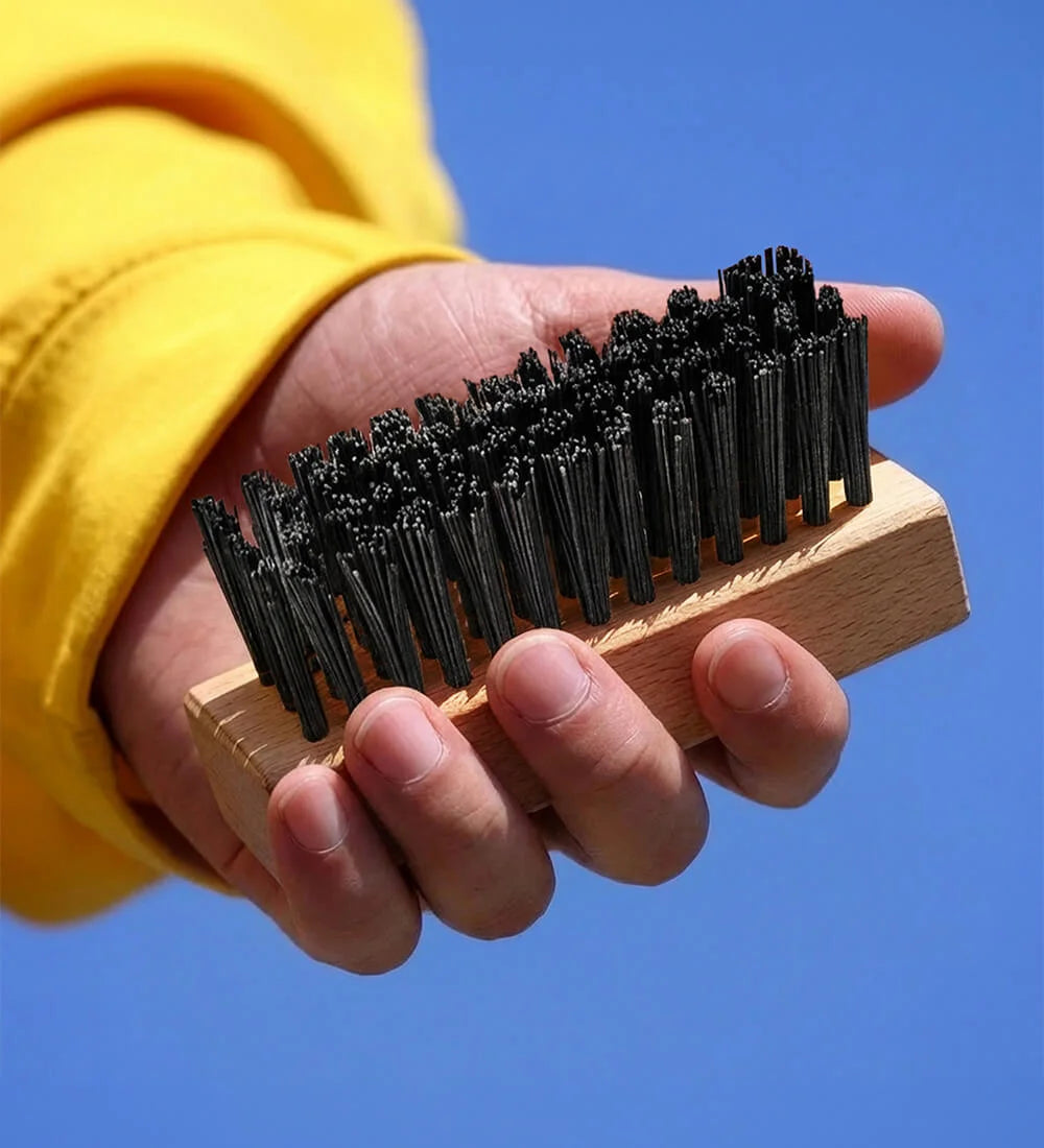 Man Holding SHOEGR Hard Shoe Brush