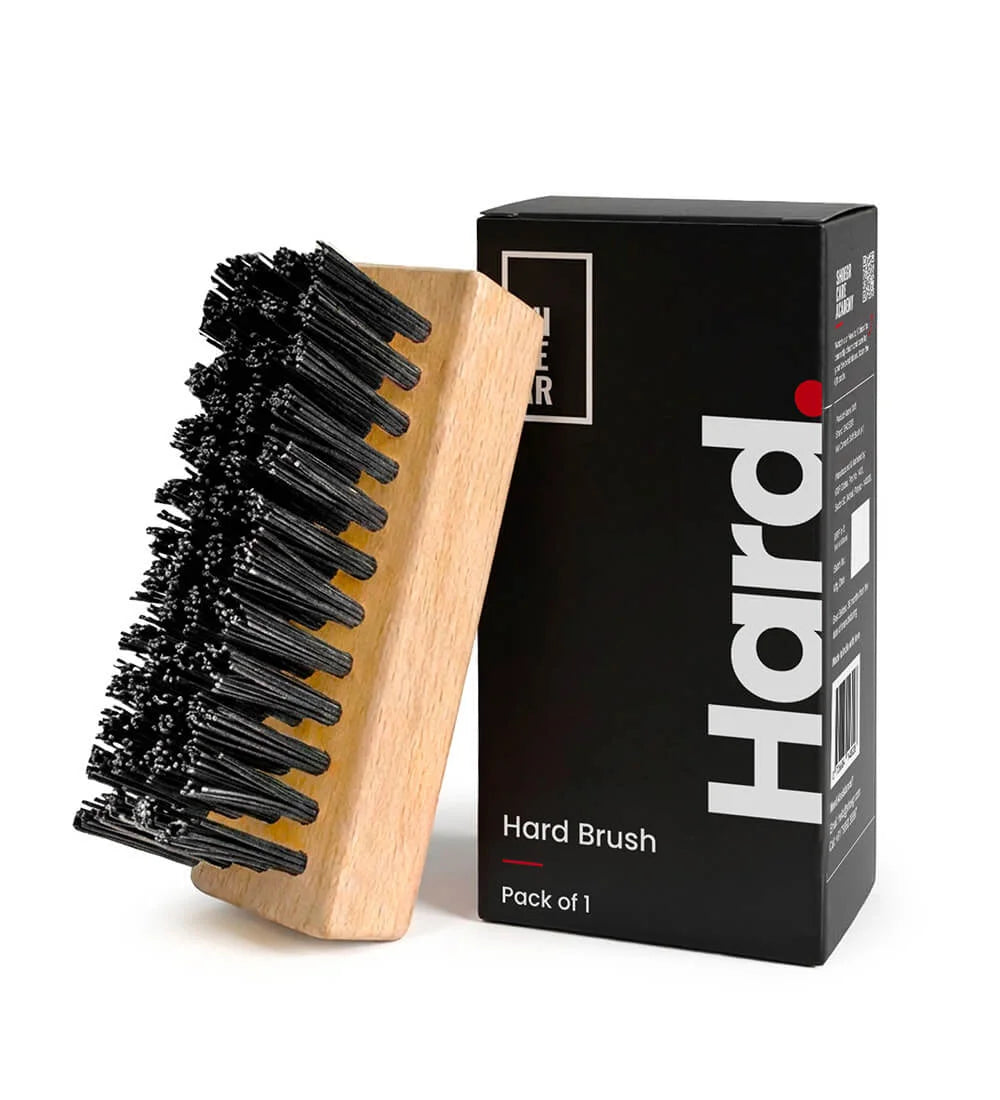 SHOEGR Hard shoe brush with wooden handle and black bristles next to its packaging box on a white background