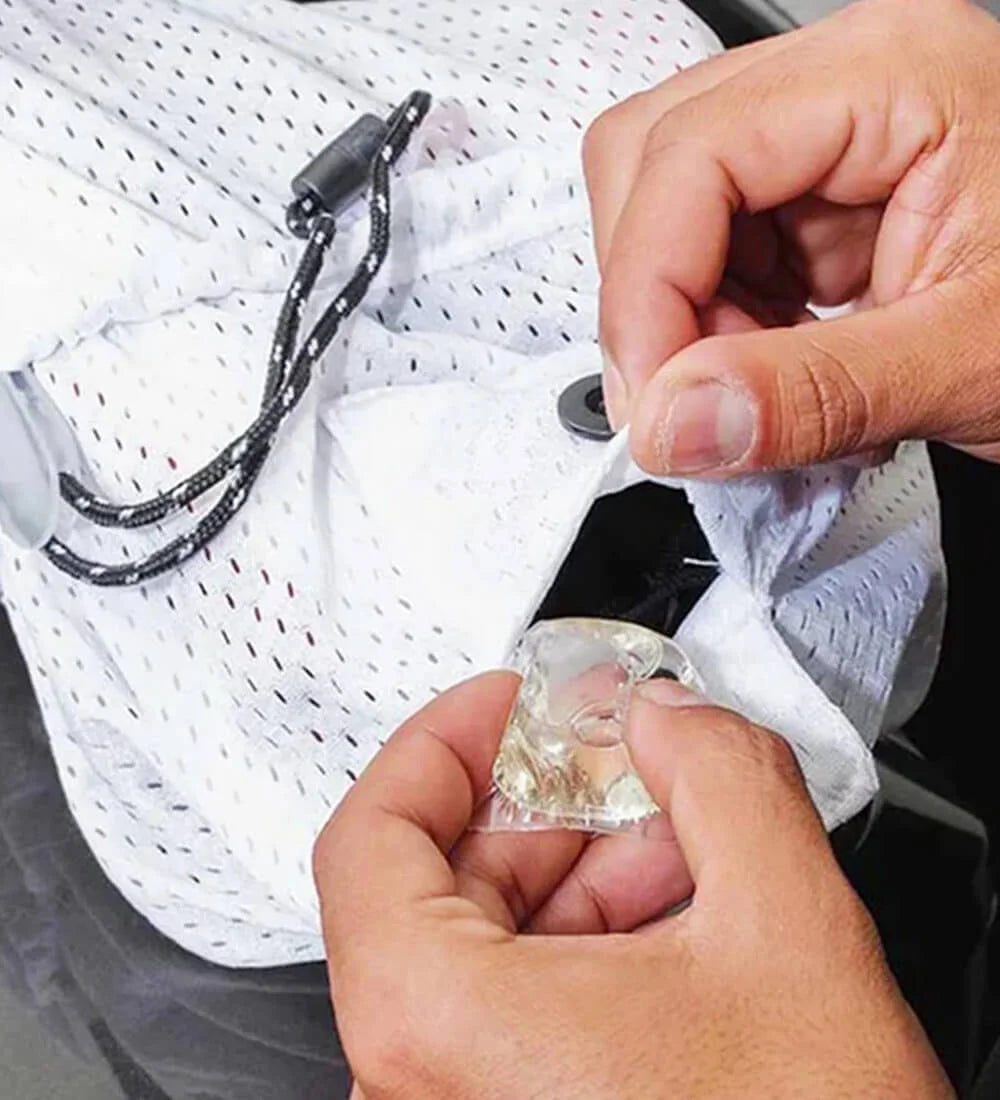 Placing detergent pod inside laundry bag for shoe wash