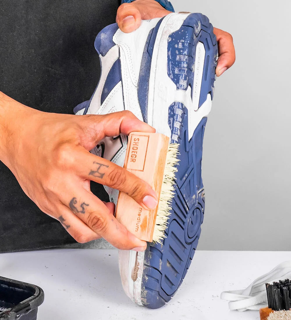 Man cleaning a Nike Sneaker Midsole with SHOEGR Medium Brush