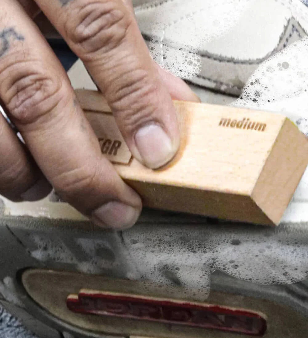 Cleaning the shoe with sneaker cleaner and brush