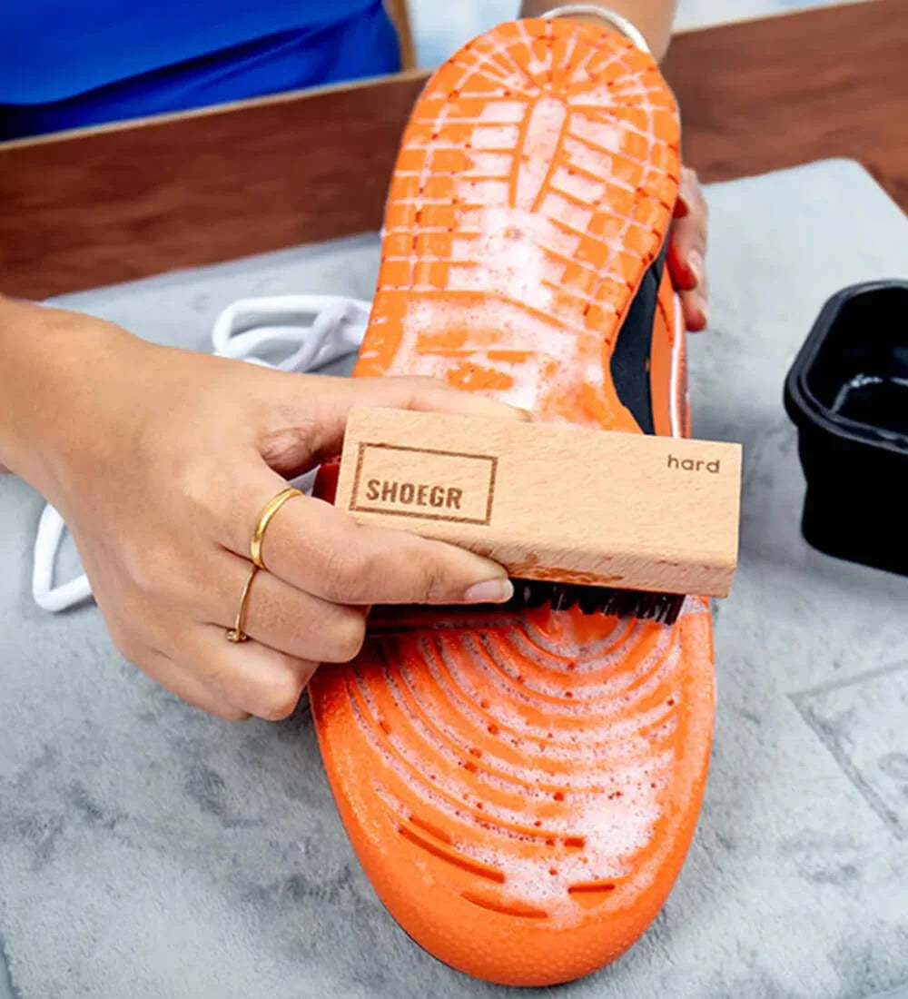 Cleaning the sole of the shoe with hard brush
