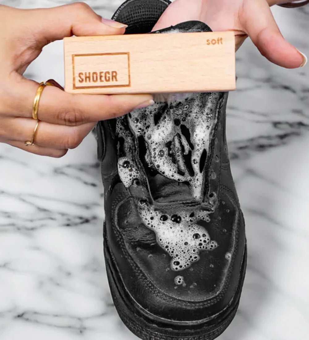 Cleaning black leather sneaker uppers with SHOEGR soft brush